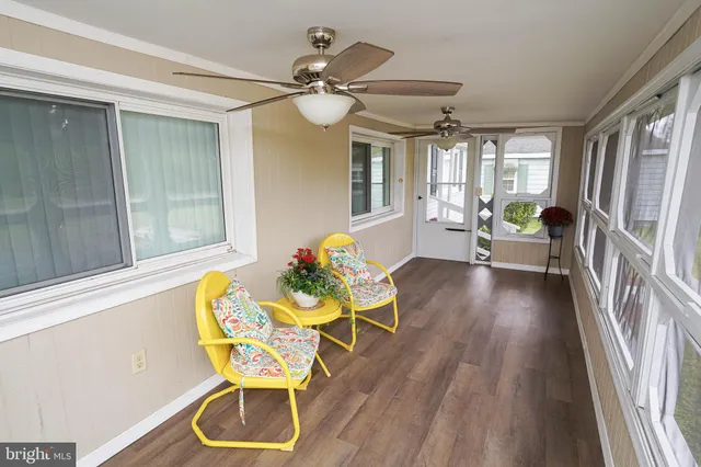a living room with dining room and wooden floor