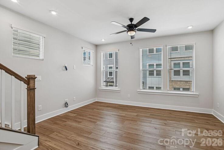 4375 Raleigh Street, Unit C1 Charlotte, NC 28213 - Photo 12 of 19 a view of empty room with wooden floor and fan