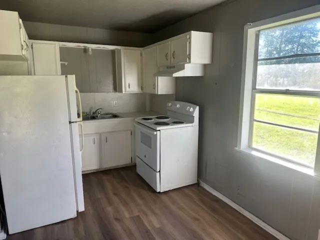 a utility room with cabinets washer and dryer