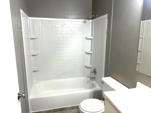 a bathroom with a tub toilet and sink