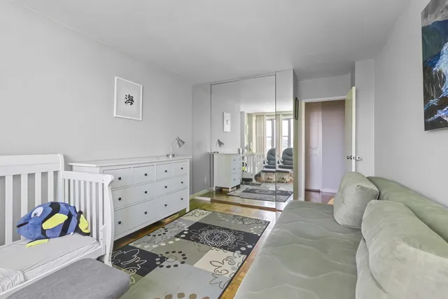 a bedroom with furniture and a rug