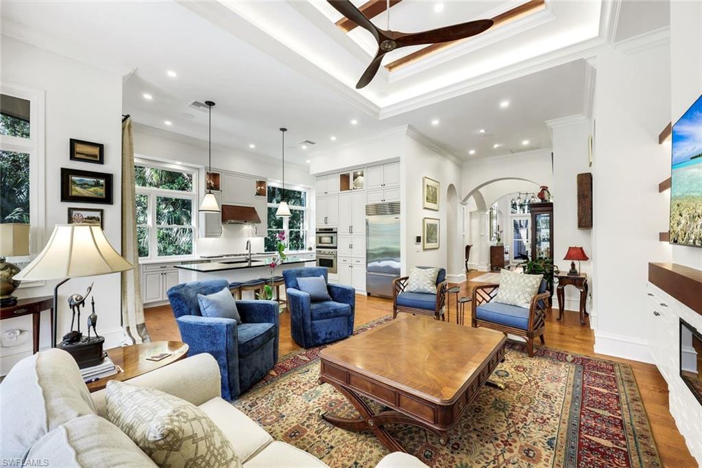 18051 Lagos Way Naples, FL 34110 - Photo 11 of 35 a living room with lots of furniture and kitchen view