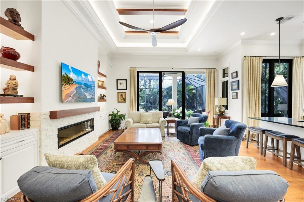 18051 Lagos Way Naples, FL 34110 - Photo 13 of 35 a living room with furniture fireplace and a large window