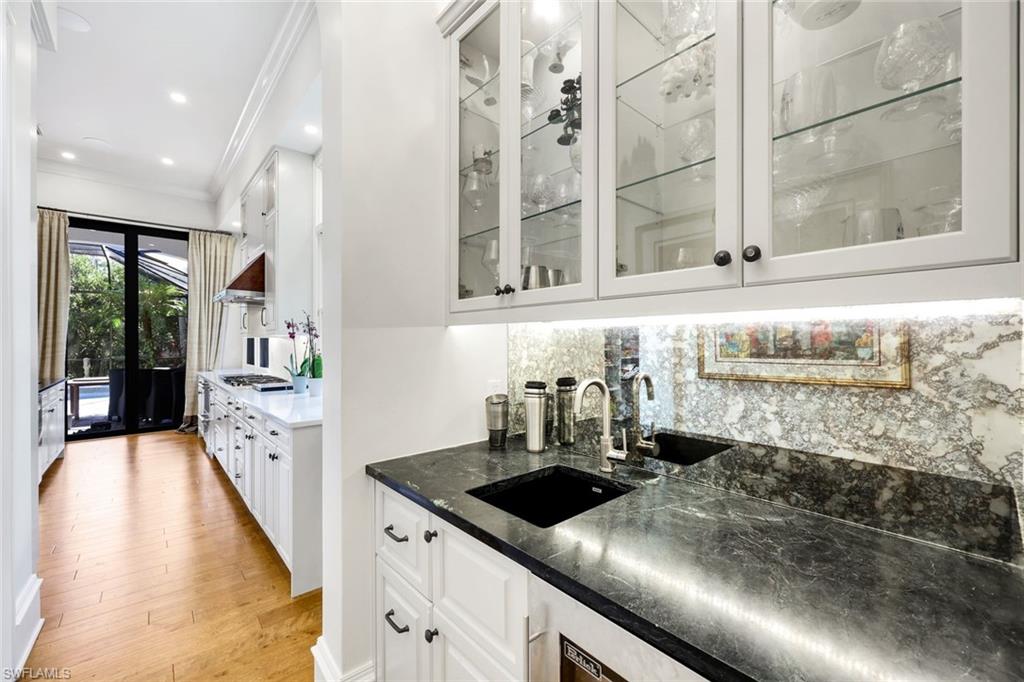 18051 Lagos Way Naples, FL 34110 - Photo 14 of 35 a kitchen with a stove and a sink