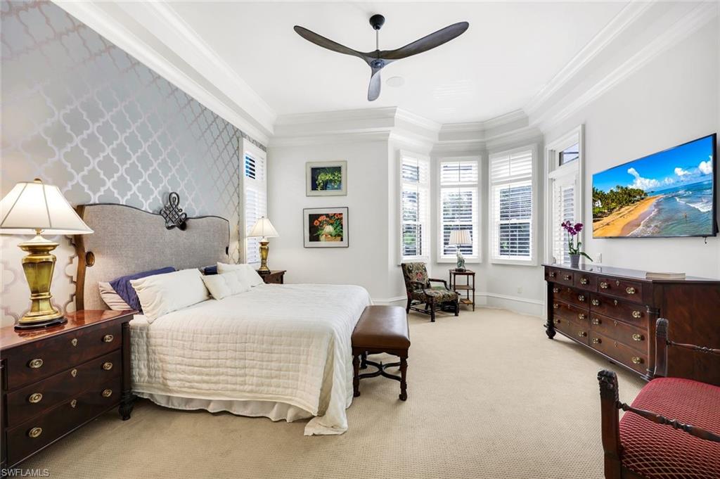 18051 Lagos Way Naples, FL 34110 - Photo 15 of 35 a bedroom with a bed a couch and dresser