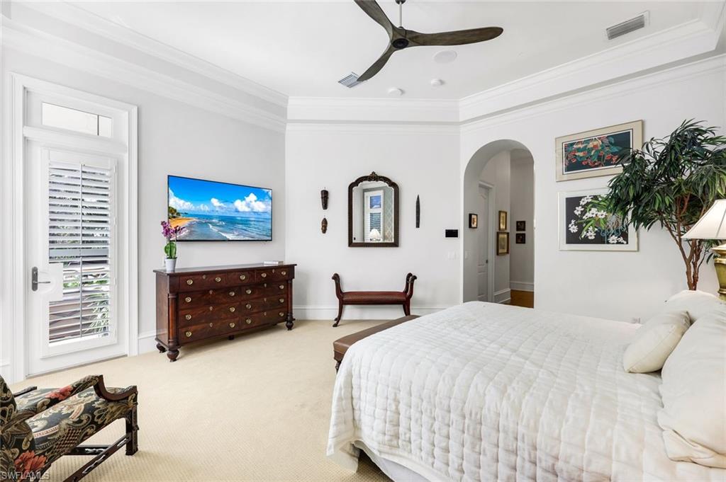 18051 Lagos Way Naples, FL 34110 - Photo 16 of 35 a bed room with a bed and a television