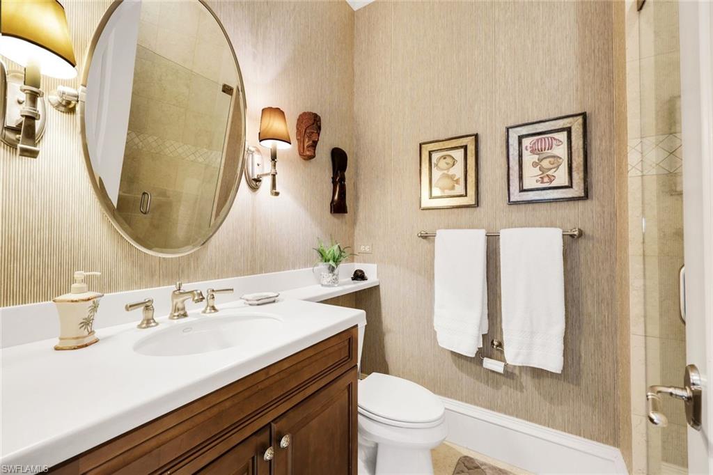 18051 Lagos Way Naples, FL 34110 - Photo 20 of 35 a bathroom with a sink mirror and toilet