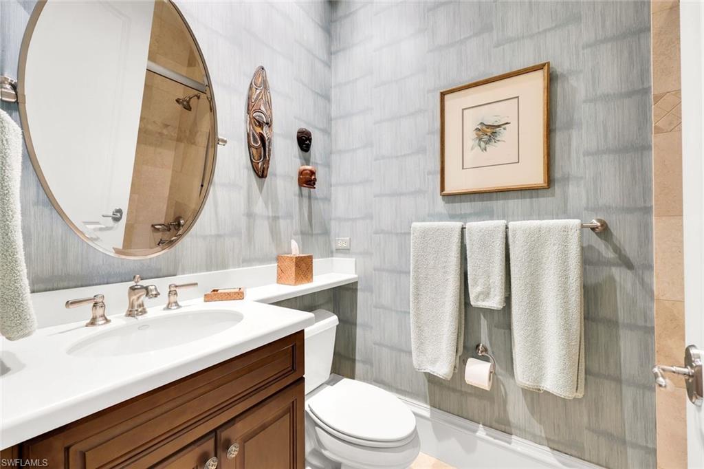 18051 Lagos Way Naples, FL 34110 - Photo 22 of 35 a bathroom with a sink mirror vanity and toilet