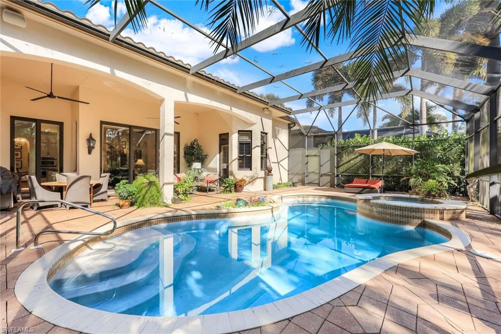 18051 Lagos Way Naples, FL 34110 - Photo 27 of 35 a view of a swimming pool with a patio
