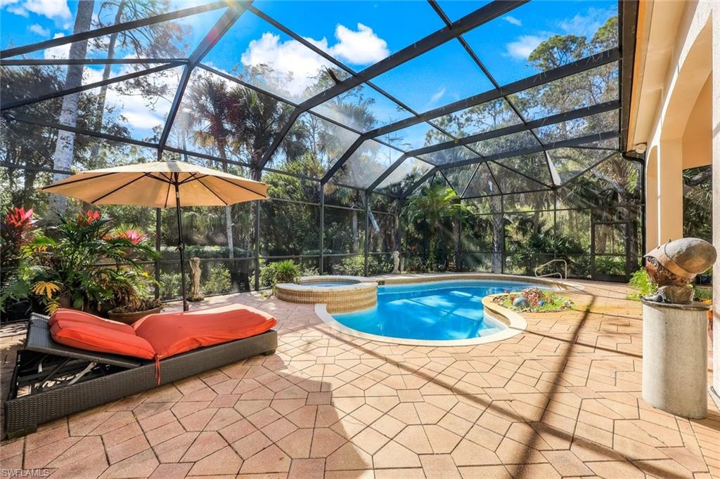 18051 Lagos Way Naples, FL 34110 - Photo 29 of 35 a view of a swimming pool with a lounge chairs