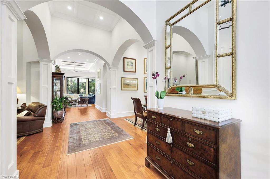 18051 Lagos Way Naples, FL 34110 - Photo 4 of 35 a living room with furniture and a wooden floor