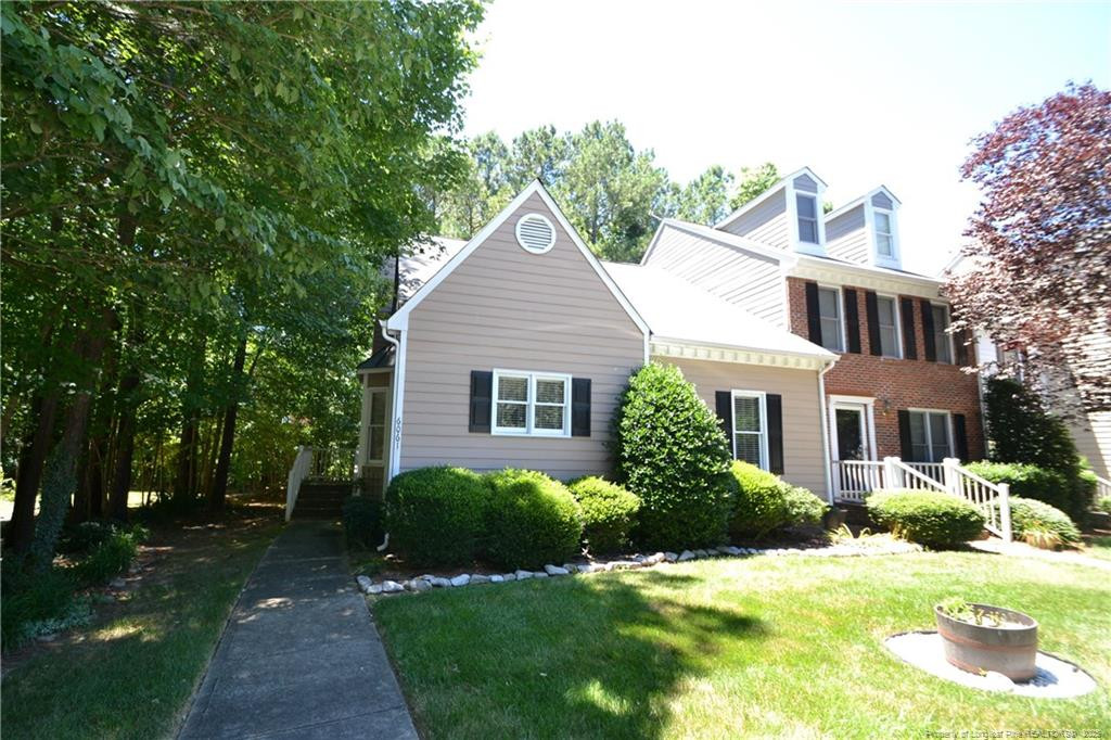 6061 Epping Forest Drive Raleigh, NC 27613 - Photo 1 of 37 a view of a house with a yard and potted plants