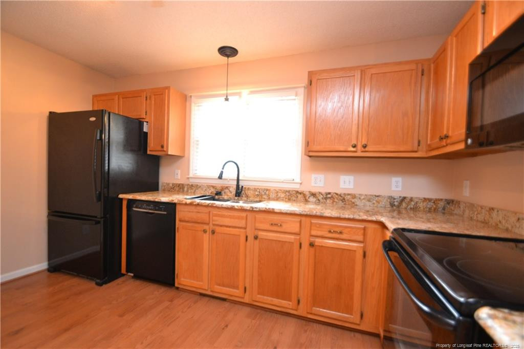 6061 Epping Forest Drive Raleigh, NC 27613 - Photo 11 of 37 a kitchen with stainless steel appliances granite countertop a refrigerator and a sink