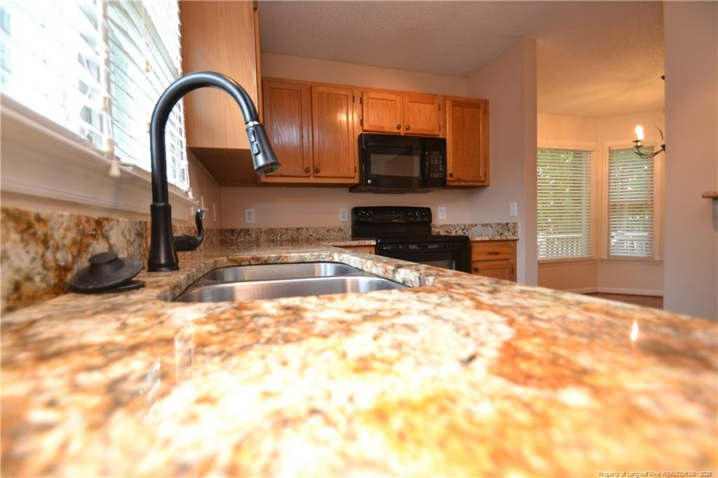 6061 Epping Forest Drive Raleigh, NC 27613 - Photo 14 of 37 a view of a kitchen with a sink and cabinets