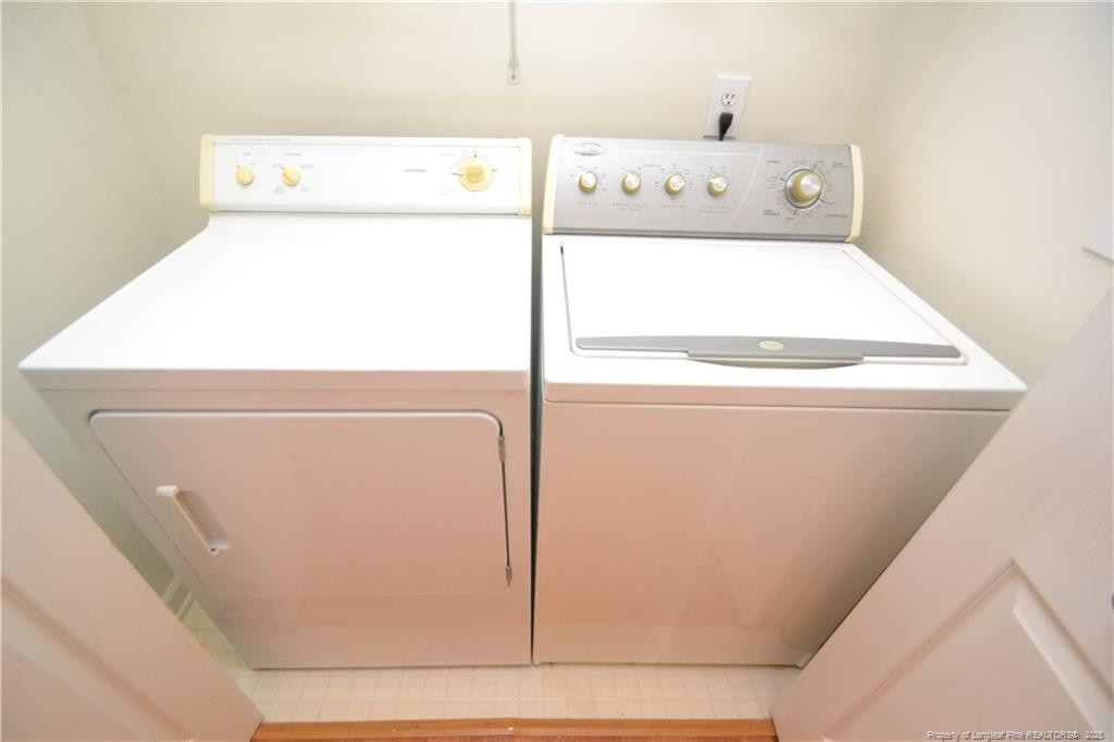 6061 Epping Forest Drive Raleigh, NC 27613 - Photo 15 of 37 a utility room with dryer and washer