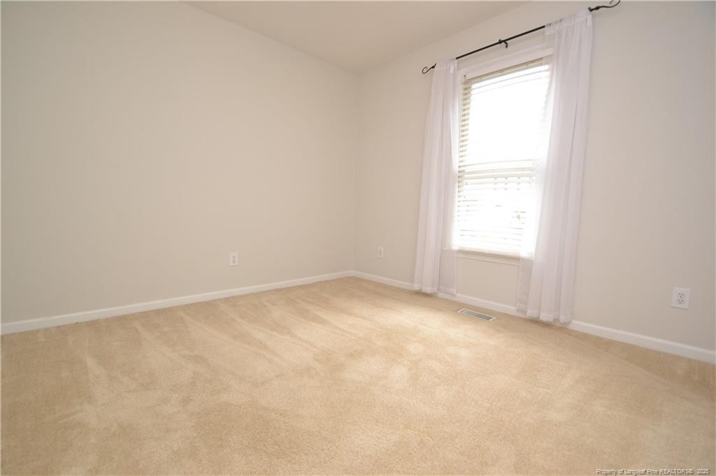 6061 Epping Forest Drive Raleigh, NC 27613 - Photo 16 of 37 an empty room with a window