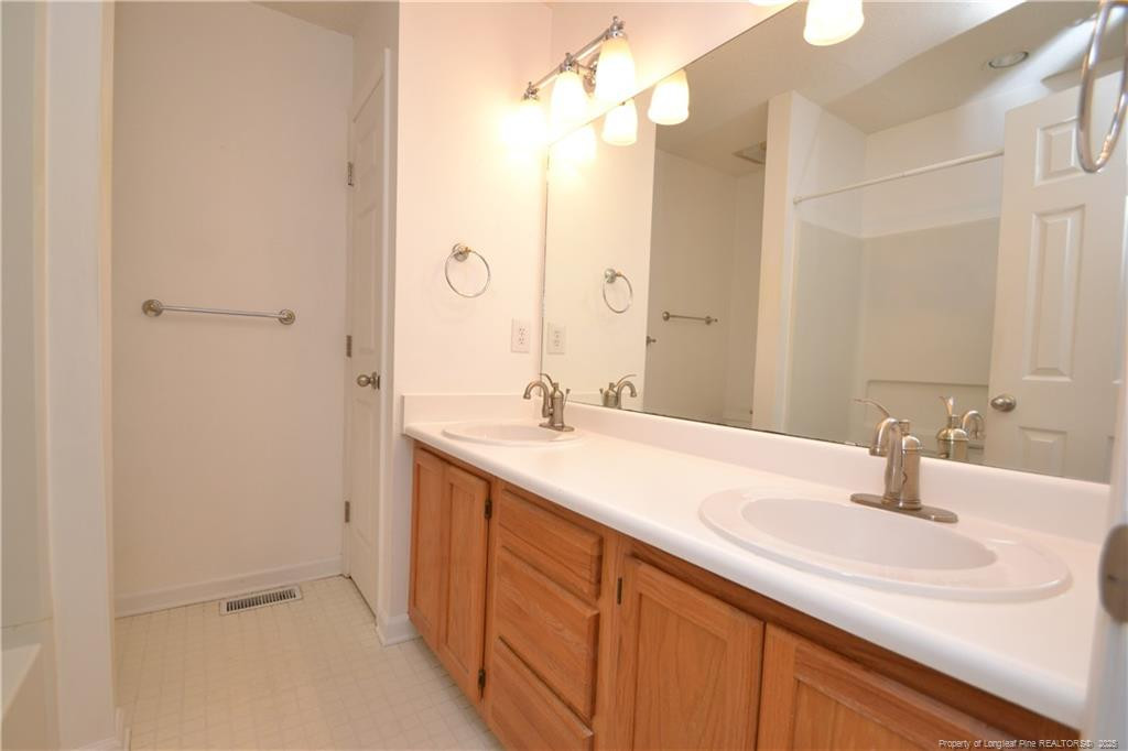 6061 Epping Forest Drive Raleigh, NC 27613 - Photo 26 of 37 a bathroom with a sink and a mirror