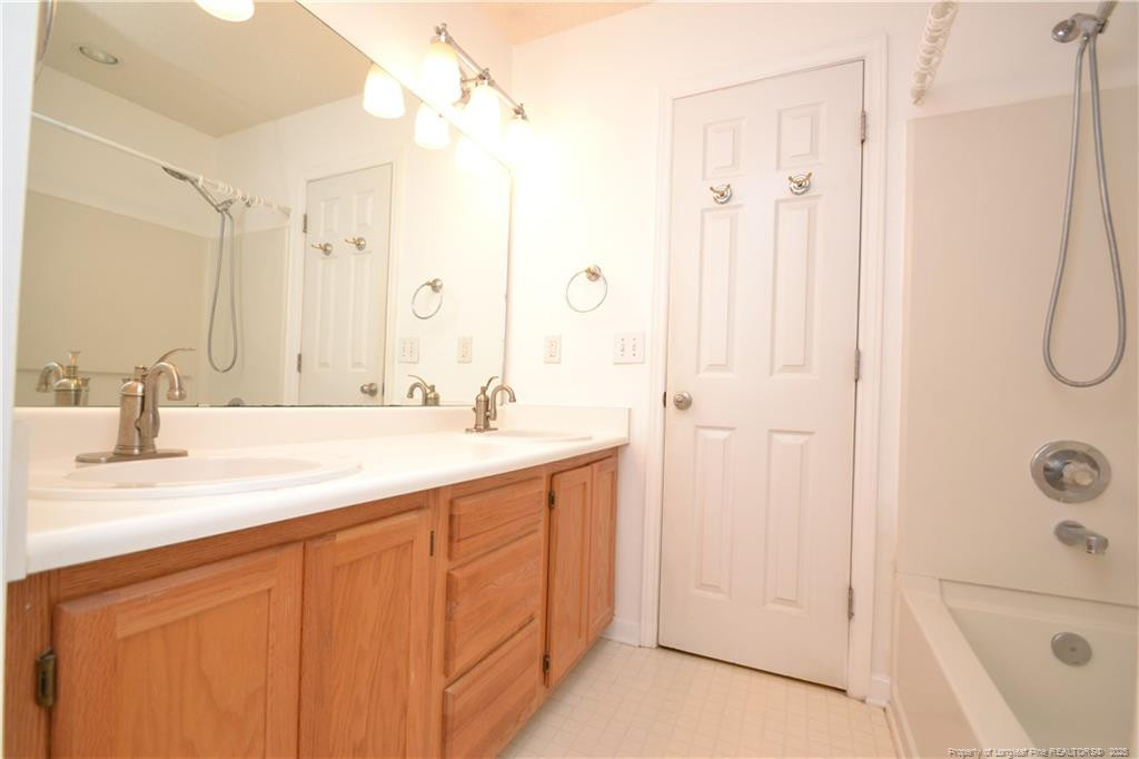 6061 Epping Forest Drive Raleigh, NC 27613 - Photo 28 of 37 a bathroom with a shower sink and mirror