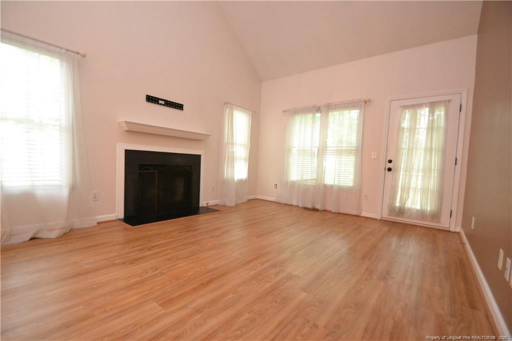 6061 Epping Forest Drive Raleigh, NC 27613 - Photo 3 of 37 an empty room with windows and fireplace