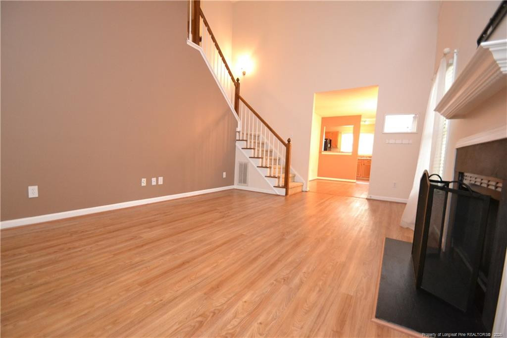 6061 Epping Forest Drive Raleigh, NC 27613 - Photo 5 of 37 a view of a livingroom with wooden floor and a ceiling fan