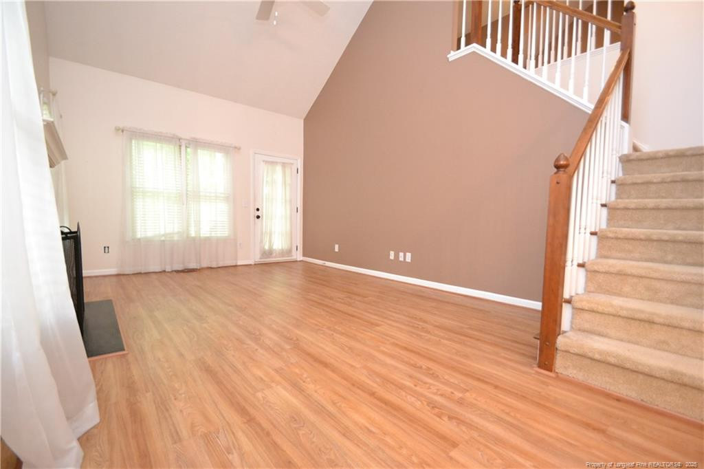 6061 Epping Forest Drive Raleigh, NC 27613 - Photo 6 of 37 an empty room with wooden floor and windows