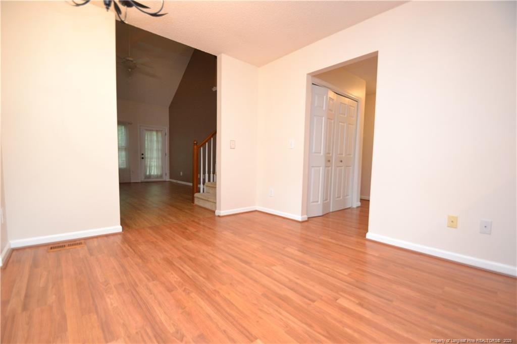 6061 Epping Forest Drive Raleigh, NC 27613 - Photo 9 of 37 a view of an empty room with wooden floor and closet