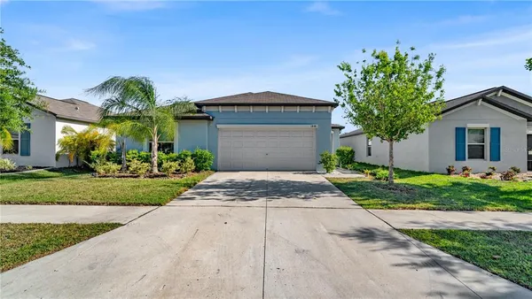 a front view of a house with a yard and garage