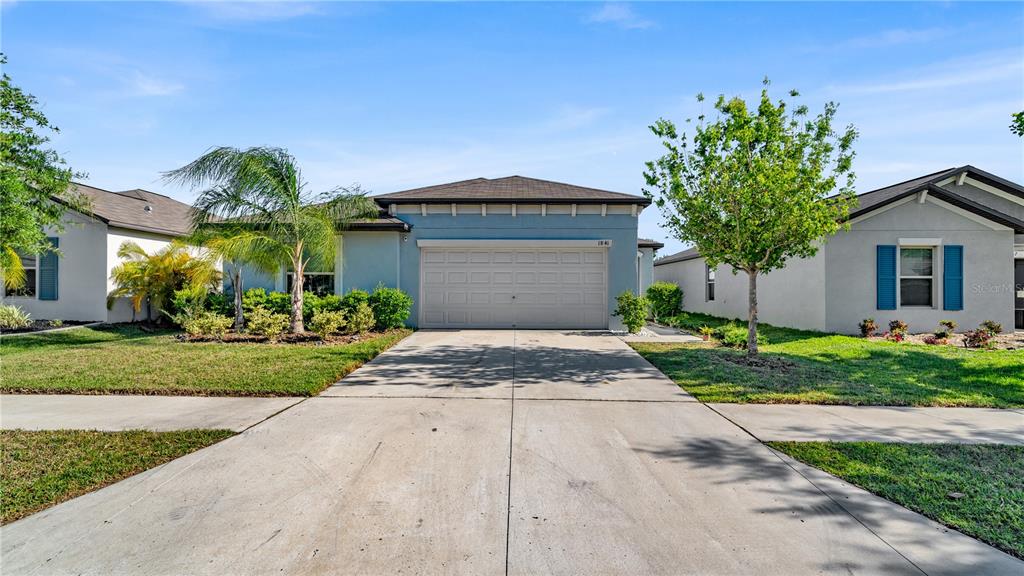1841 Crinkle Leaf Court Ruskin, FL 33570 - Photo 1 of 35 a front view of a house with a yard and garage