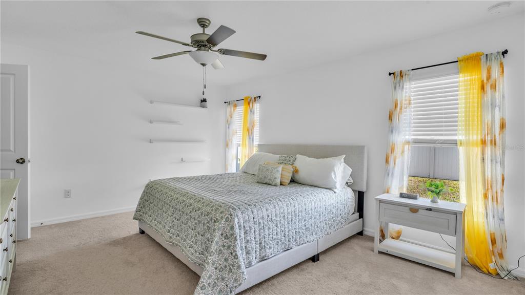 1841 Crinkle Leaf Court Ruskin, FL 33570 - Photo 20 of 35 a bedroom with a bed and a window