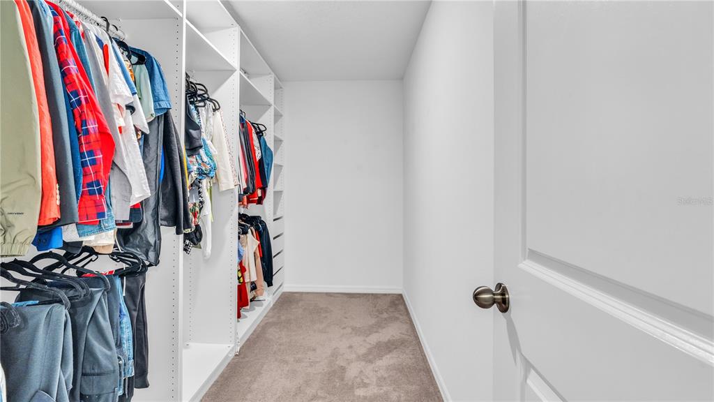 1841 Crinkle Leaf Court Ruskin, FL 33570 - Photo 22 of 35 a view of walk in closet with clothes