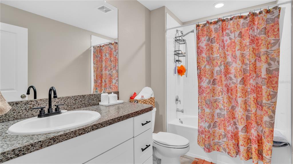 1841 Crinkle Leaf Court Ruskin, FL 33570 - Photo 30 of 35 a bathroom with a granite countertop sink and a mirror