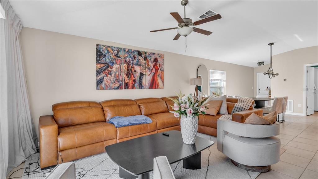 1841 Crinkle Leaf Court Ruskin, FL 33570 - Photo 3 of 35 a living room with furniture a rug and a ceiling fan