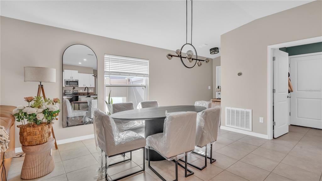 1841 Crinkle Leaf Court Ruskin, FL 33570 - Photo 9 of 35 a view of a dining room with furniture window and wooden floor