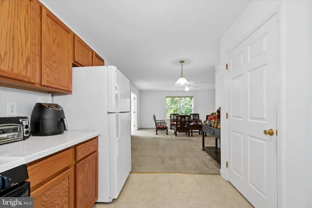 a kitchen with refrigerator and cabinets
