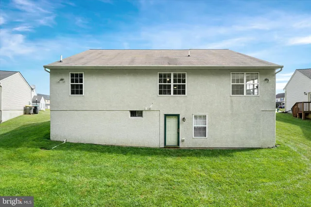 a view of backyard with barbeque grill potted plants and wooden fence