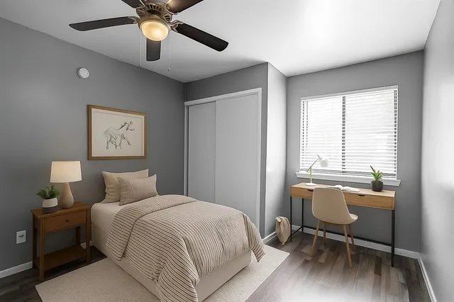 a bedroom with a bed and a desk