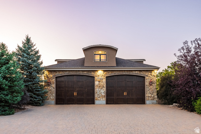 694 West Cephus Road Draper, UT 84020 - Photo 106 of 148 Stone and stucco facade featuring two arched wood-finish garage doors