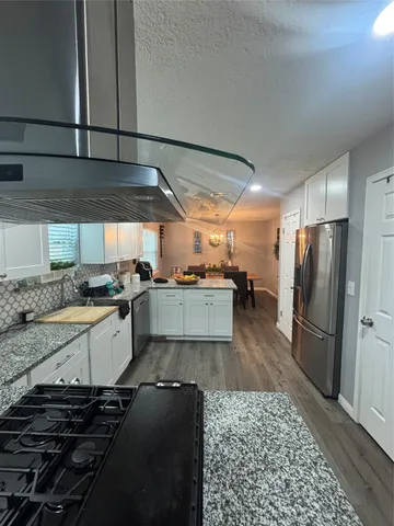 a kitchen with a refrigerator and a sink