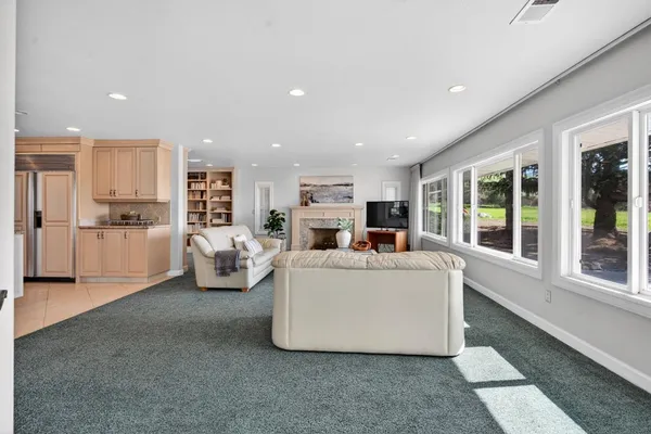 a living room with a book shelf and a book shelf