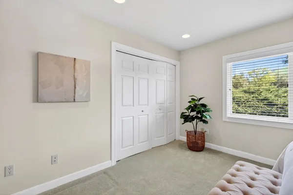 a living room with furniture a rug and a window
