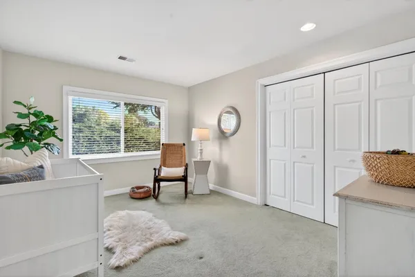 a living room with furniture a rug and a chandelier