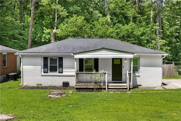 a backyard of a house with table and chairs