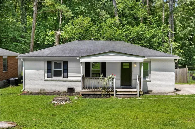 a backyard of a house with table and chairs