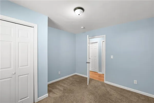 an empty room with closet area