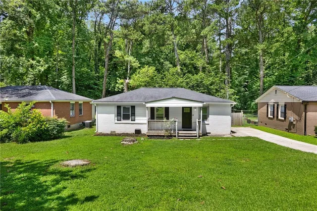 a view of a house with a yard porch and sitting area