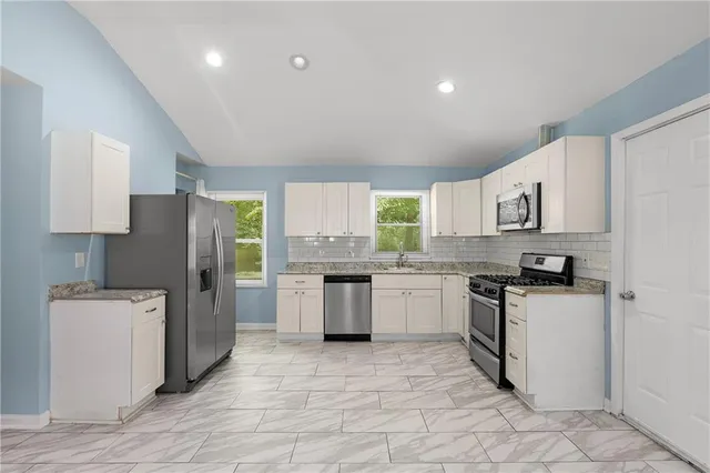 a kitchen with a sink stove and refrigerator