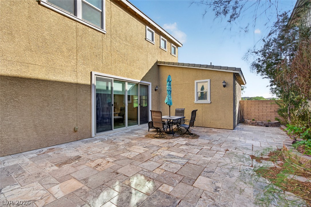 1100 East Sunset Road Henderson, NV 89011 - Photo 49 of 58 A spacious, stone-paved patio offers an ideal setting for outdoor dining and relaxation.