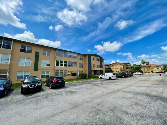 a front view of a building with a yard