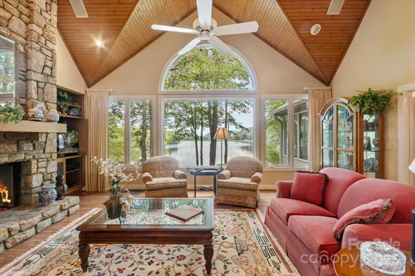 a living room with furniture a fireplace and a large window
