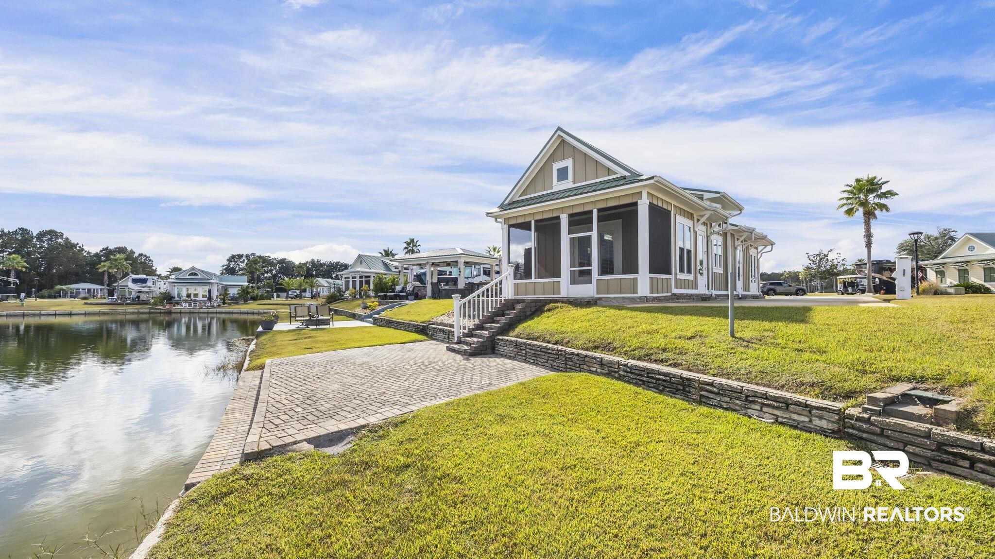 12004 Raptor Court Elberta, AL 36530 - Photo 3 of 57 Rear view of house with a lawn, a sunroom, and a water view